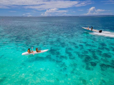 Mauritius vacation, couple man and woman in kayak in a bleu ocean in Mauritus