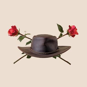 Cowboy hat and rose flowers wild west party concept.