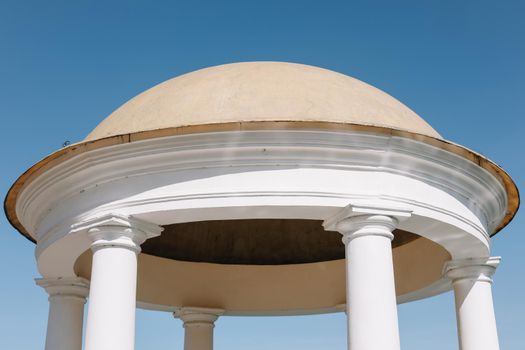 Rotunda against a blue sky. Ancient temple with dome