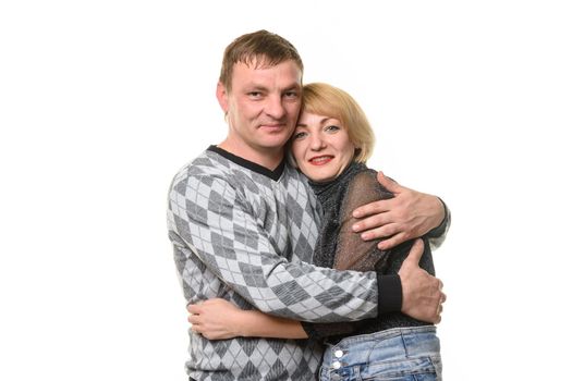 Man and woman hugging and looking into the frame, isolated on a white background