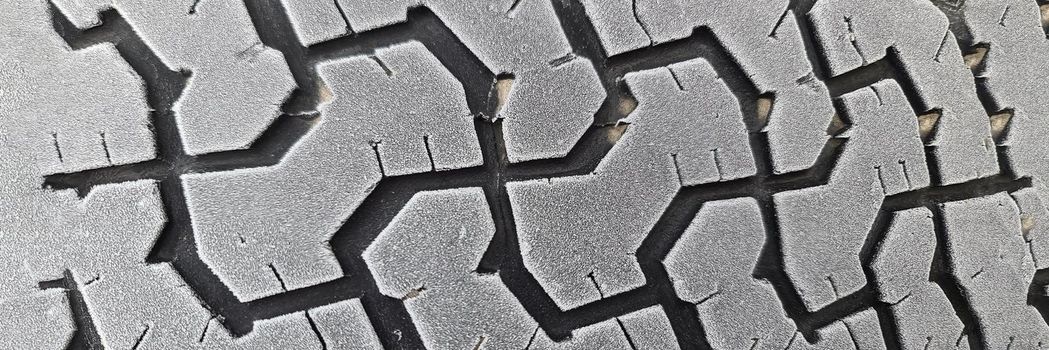 Winter tires on car wheel with frost closeup