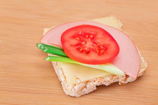 Rice Cake Sandwich with Tomato, Sausage, Green Onions and Cheese
