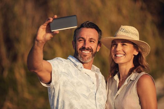 Remember to make visual memories. Cropped shot of an affectionate couple taking a selfie together.