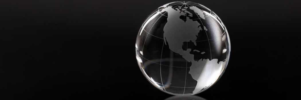 Closeup of glass globe on black background