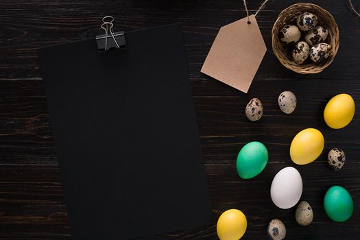 Greeting card with paschal eggs on rustic, wood table