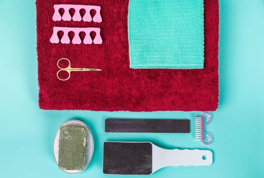 Top view of manicure and pedicure equipment on blue background