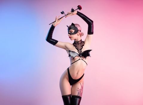 sexy woman in a leather cat mask with a leather rose bdsm in underwear
