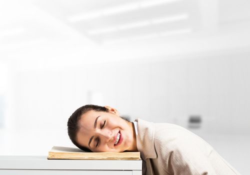 Exhausted business woman sleeping on desk