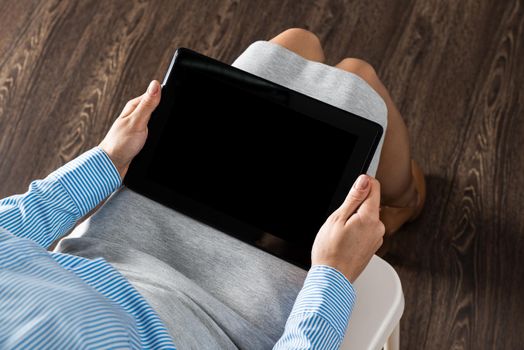 business woman with tablet on her lap