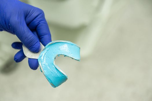 blue alginate filled mold for dental impression