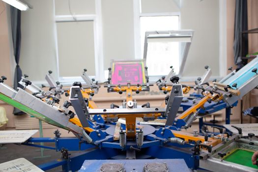 Serigraphy silk screen print process at clothes factory