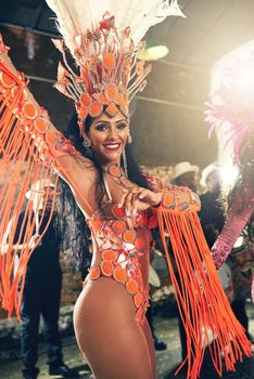 The thrill of performing live. Cropped portrait of a beautiful samba dancer performing at Carnival with her band.