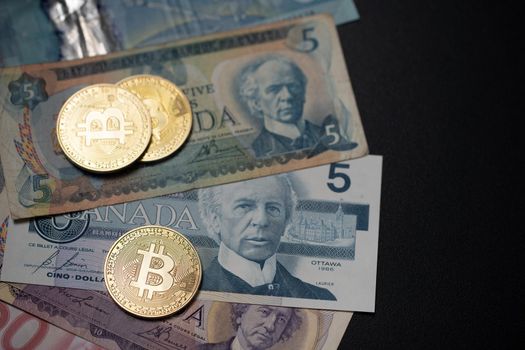 Bitcoin on old Canadian Dollar banknotes. BTC and CAD, trading digital money
