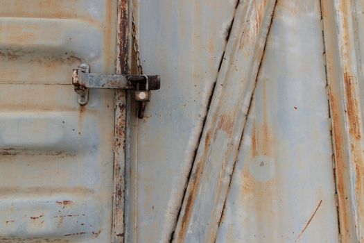 Metal locked padlock at Vintage railroad container doors gates.
