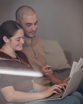 Being an adult means paying bills. Shot of a young couple paying bills together using a laptop.