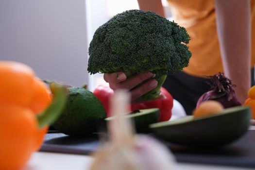 Broccoli and different vegetables in kitchen closeup