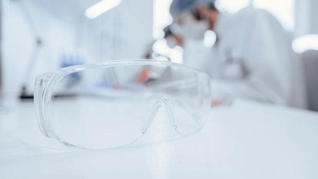 background image of scientists working in a scientific laboratory .
