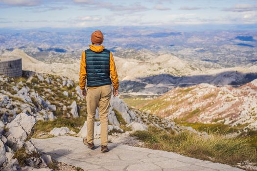 Man traveller in mountain landscape at national park Lovcen, Montenegro. Travel to Montenegro concept