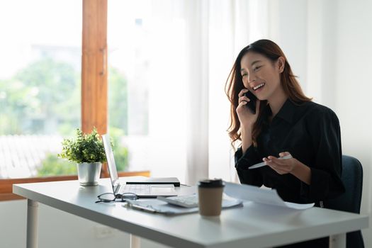 Portrait of attractive entrepreneur asian woman, business woman calling on mobile phone for accounting finance consultant