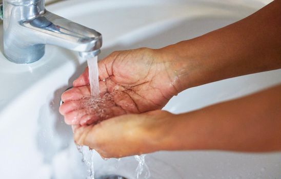 Know the worth of water before all wells run dry. Cropped shot of an unrecognizable male washing his hands in a hand basin at home.