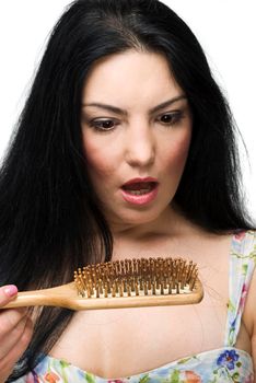 Shocked woman loss hair on hairbrush