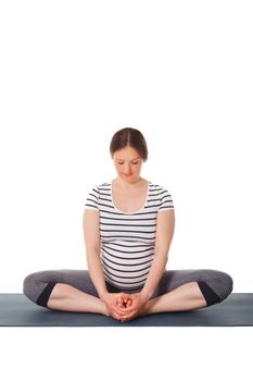 Pregnant woman doing yoga asana Baddha Konasana