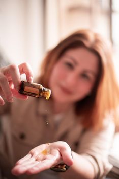 Woman try dropping with essence of oils, humidifier doTERRA