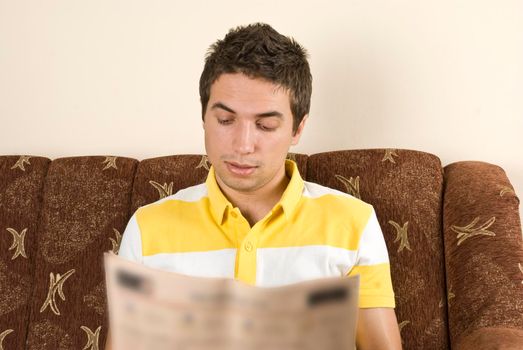 Man read the news in a sofa home