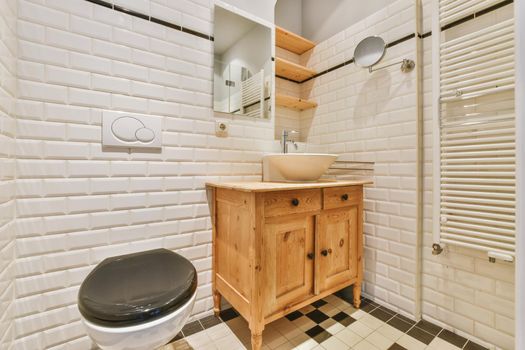 The bathroom is surrounded by brick-shaped tiles
