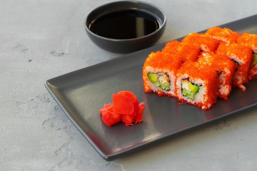California sushi roll served on black ceramic plate