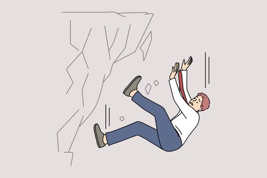 Stressed businessman fall down from rock