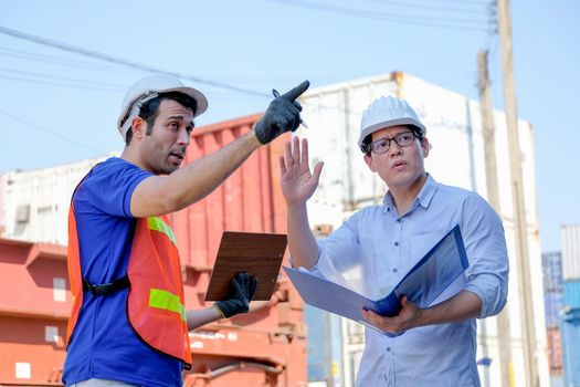 Technician and manager argue with the problem in cargo containers shipping area.