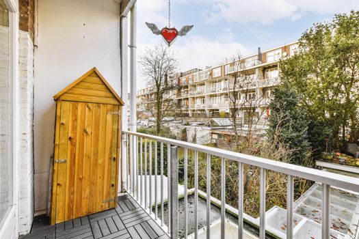 Narrow balcony with wooden unusual cabinet