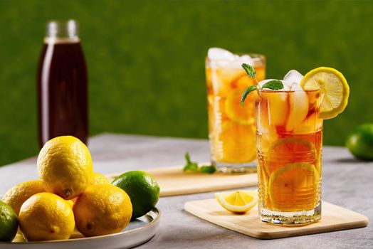 Iced tea. Traditional iced tea with lemon and ice in tall glasses