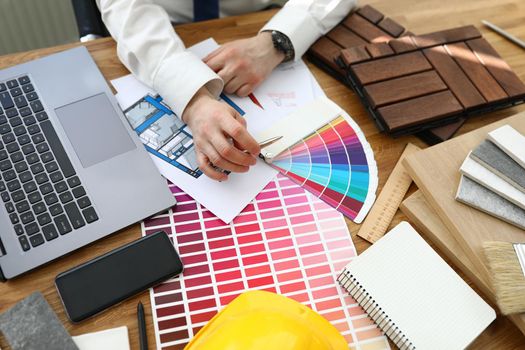 Interior designer working at project, palette on workplace