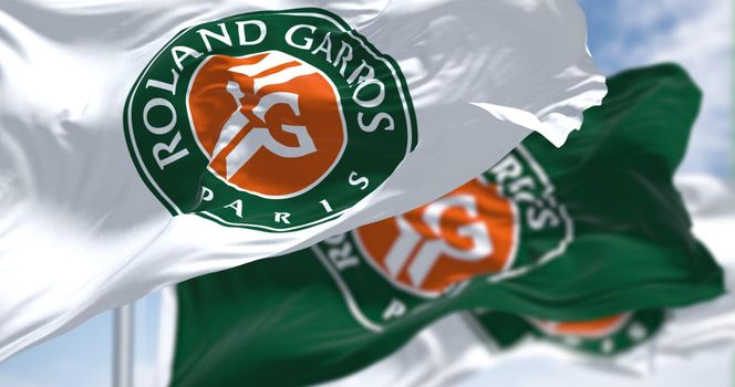 Paris, France, April 2022: three flags with the Roland-Garros logo waving in the wind