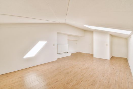 Spacious empty room with parquet floors