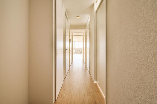 Straight long corridor in white tones