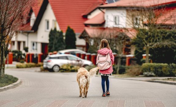 Girl and golden retriever dog