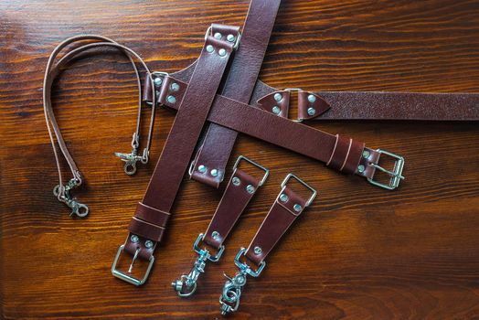 Stylish handmade leather belt on wooden background for mens fashion