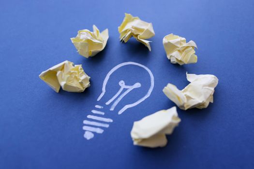 Chalk lightbulb with crumpled papers, creativity and inspiration