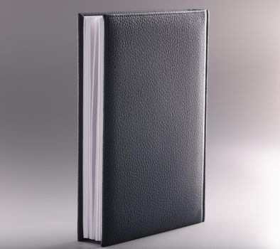Black leather notebook or diary on grey background