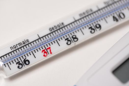 Maximum analog thermometer on white background with numbers for temperature reading