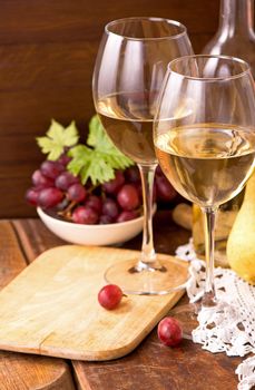 white wine and fruits. Wine and grapes in vintage setting on wooden table