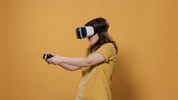 Woman winning difficult level playing game using vr goggles and console controller