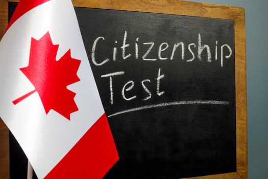 Flag of Canada and Citizenship Test on a chalkboard.