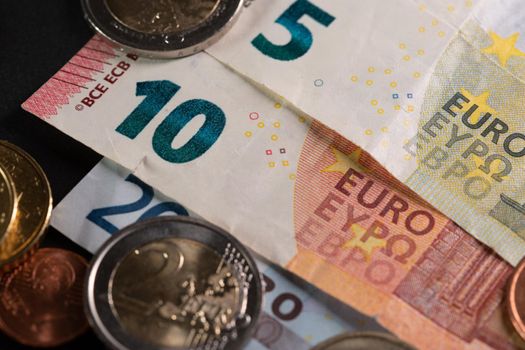 Two Euro Coin on top of EUR Banknotes. Ten Euros from Europe. Currency Market in EU
