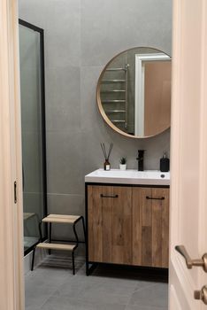 Large mirror over vessel sink in stylish bathroom interior