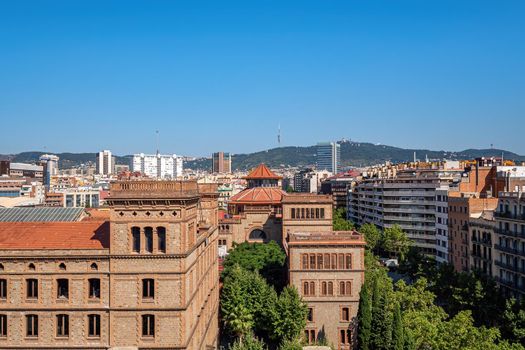 View of city with old historical and modern buildings in the center of Barcelona on sunny day.