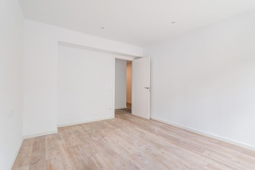 Empty white room after renovation with dusty wooden floor